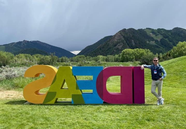 Tripp Donnelly standing next to the IDEAS sculpture at the Aspen Ideas festival